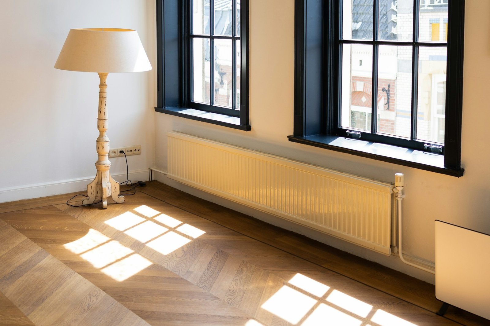 Nahaufnahme eines Thermostatkopfs an einem weißen Heizkörper